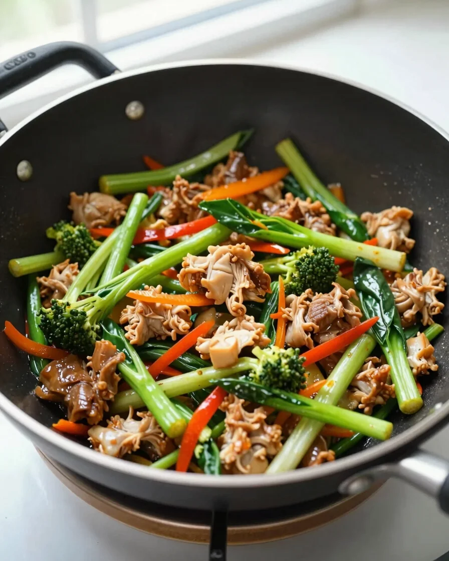 Overhead shot of a vibrant chicken and vegetable stir-fry in a wok, natural window daylight, rich saturated colors, shal