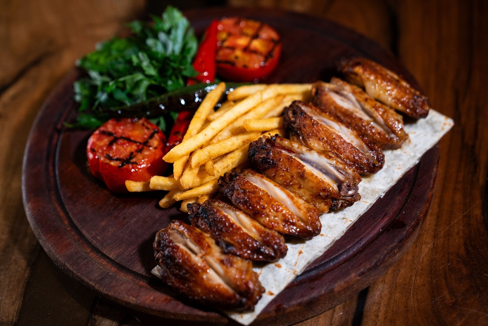 Turkish-Style Grilled Chicken Wings with Fries, Charred Tomatoes and Parsley