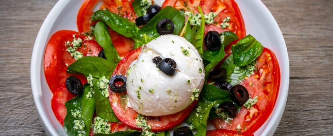 Burrata Tomato Salad with Baby Spinach, Black Olives and Pesto