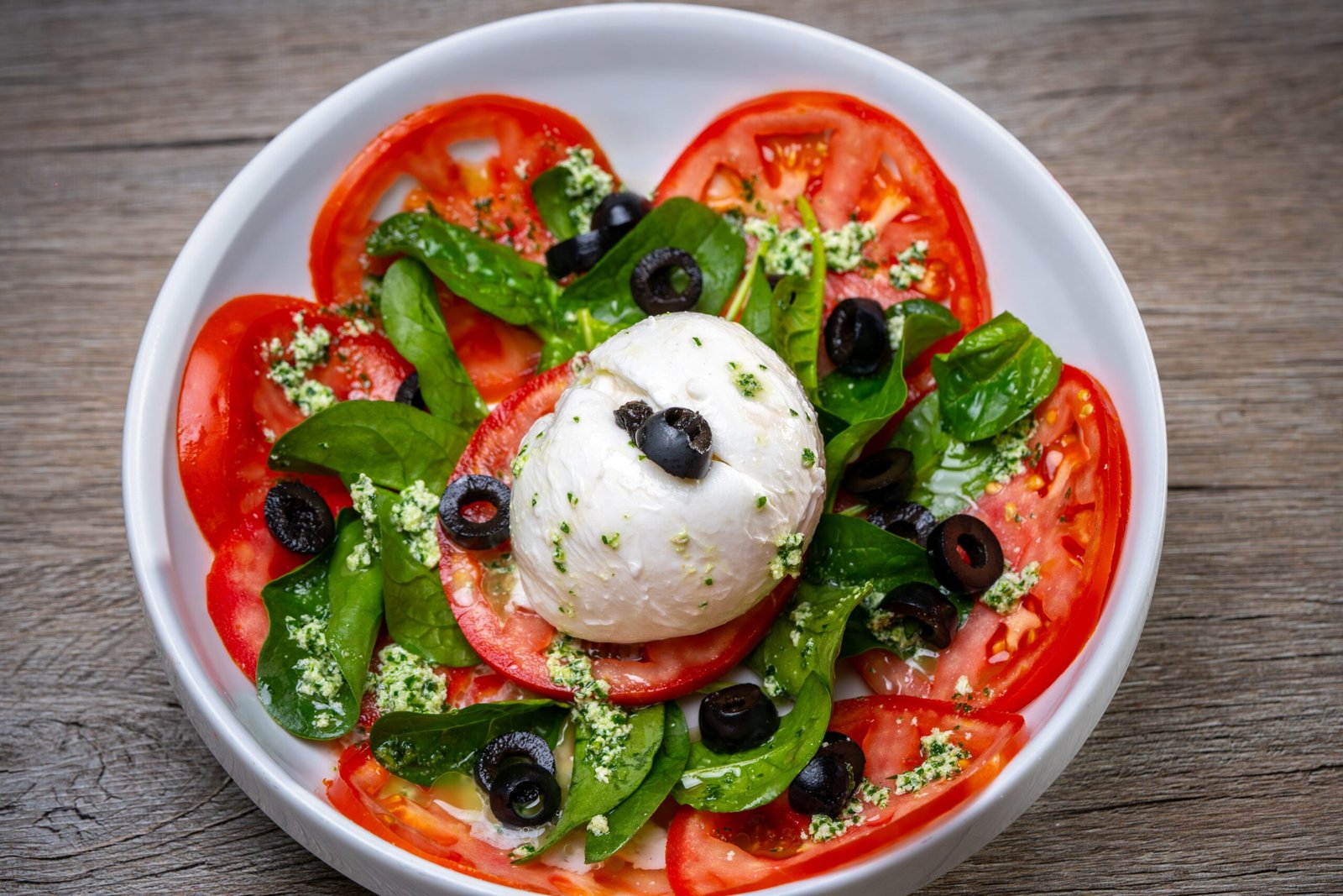 Burrata Tomato Salad with Baby Spinach, Black Olives and Pesto